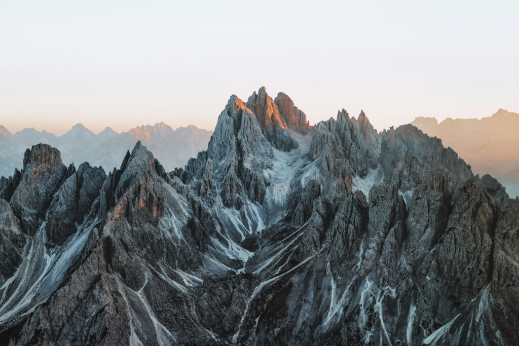 A mountain range with snow covered mountains in the background